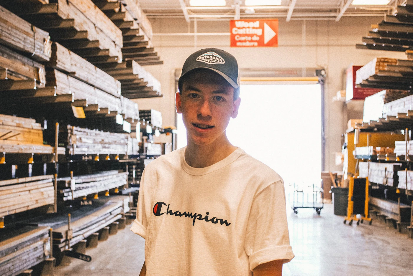 A young worker smiling in a building supply warehouse